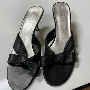 Vintage slip-on used black sandals with short heel.